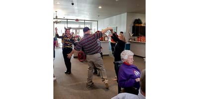Residents enjoying a lively activity in the common area