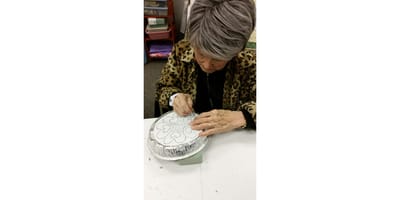 Resident engaged in a crafting activity indoors