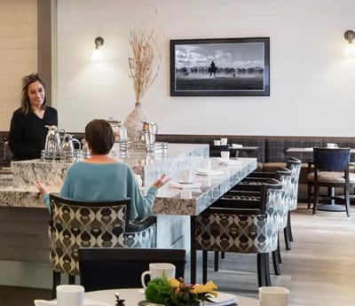 Dining area with residents and staff conversing