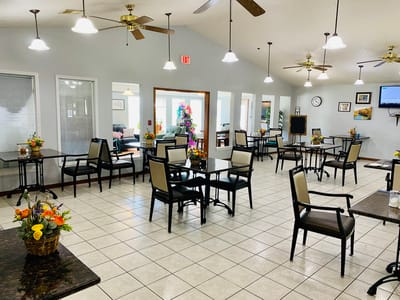 Bright dining area with tables and floral arrangements
