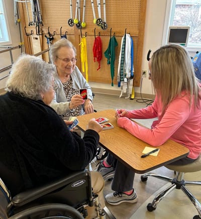 Residents playing a card game at a table
