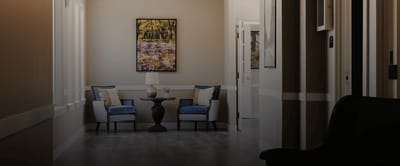 Interior hallway with chairs and artwork