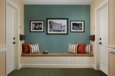 Interior hallway with framed photos and seating area