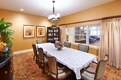 Bright dining room with a large table and floral centerpiece