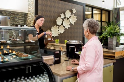Staff serving snacks at a dining area