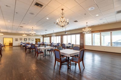 Bright dining room with chandeliers and tables