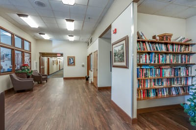 Interior hallway with bookshelves and seating