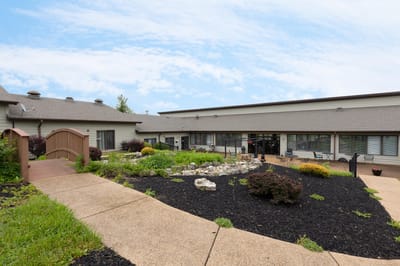 Exterior view of assisted living facility with garden