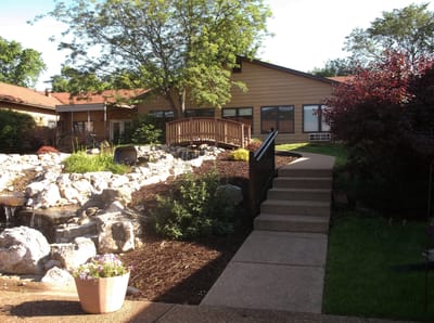 Pathway leading to the entrance of the facility with landscaped garden