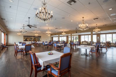 Interior view of a dining room with tables and chandeliers