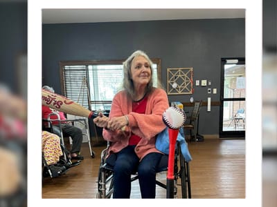 Resident enjoying a playful moment in an activity room