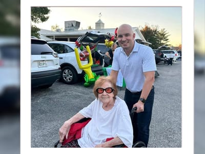 A resident and staff member smiling at an outdoor event