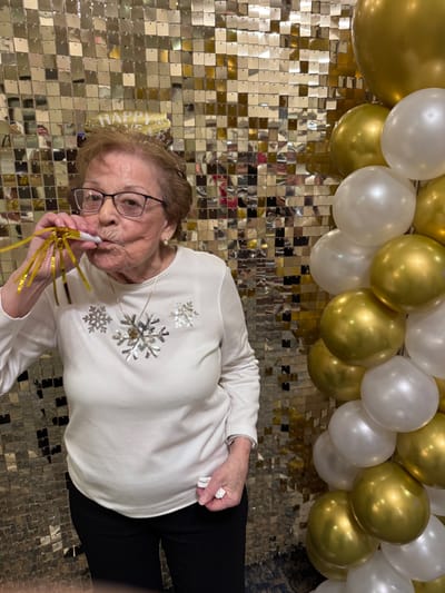 Resident celebrating with a party hat and decorations