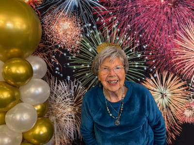 Resident celebrating with fireworks backdrop