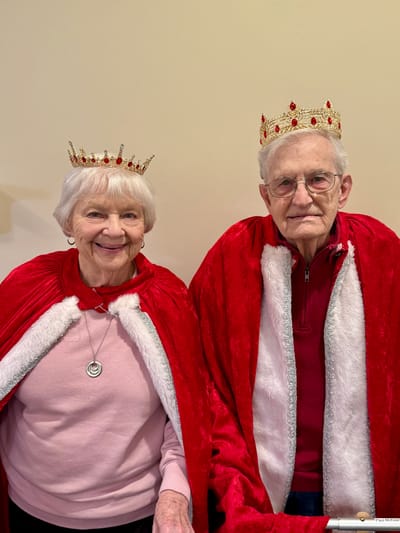 Two residents dressed as royalty with crowns and capes
