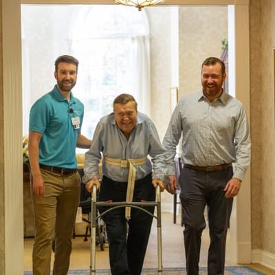 Staff assisting a resident in a cheerful interior