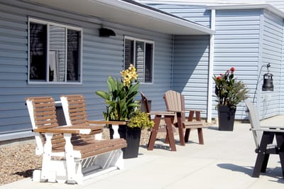 Outdoor seating area with chairs and plants