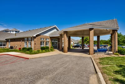 Exterior view of Pine Grove Manor entrance with awning