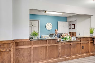 Reception area with a smiling staff member