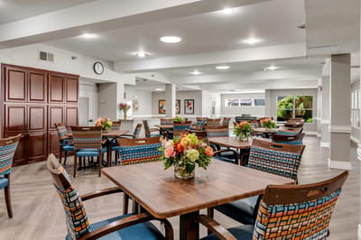 Bright common area with tables and floral centerpieces