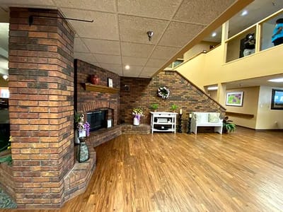 Interior common area with brick fireplace and decor