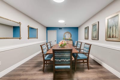 Dining area with a large table and decorative flowers