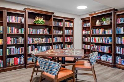 Cozy interior library with bookshelves and seating