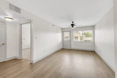 Empty resident room with light wood flooring