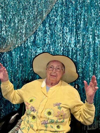 Resident posing with decorative backdrop