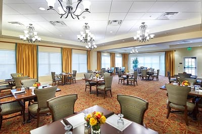 Bright dining room setup with tables and floral centerpieces