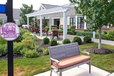 Outdoor seating area with gardens and building facade