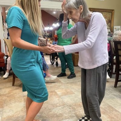 Staff assisting a resident in a common area