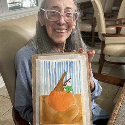A resident showcasing their artwork in a common area