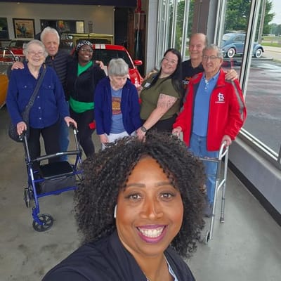 Group of residents and staff smiling in a common area