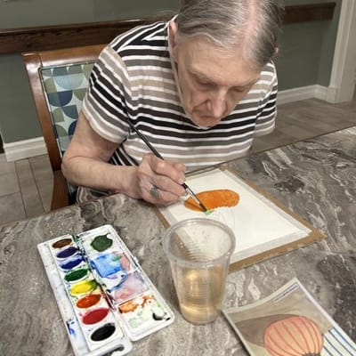Resident painting during an activity session.