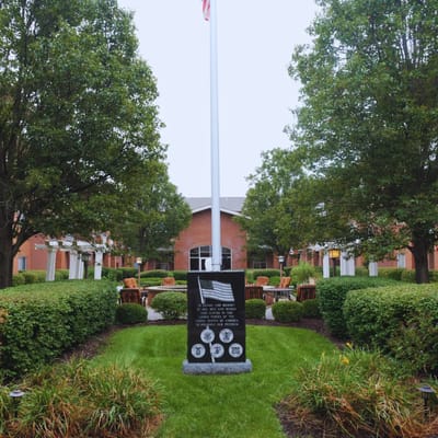 Outdoor gathering space with garden and flagpole