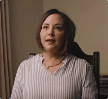 Avalon Memory Care, memory care in Fort Worth, TX — Woman speaking in a well-lit indoor setting