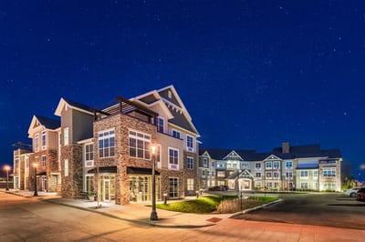 Exterior view of a senior living facility at night