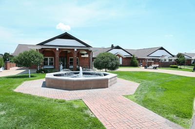 Exterior view of the retirement center with a fountain