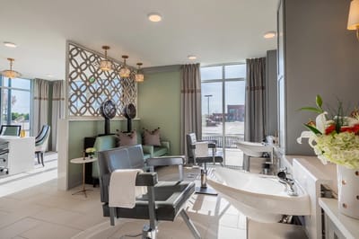 A modern hair salon area with stylish seating and equipment