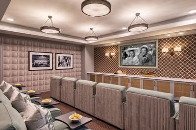 A cozy movie room with seating and snacks