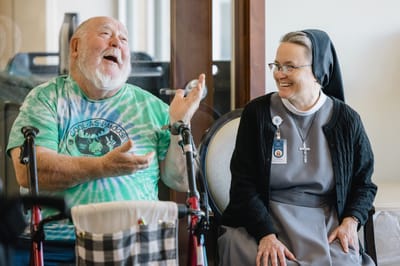 Resident and staff member enjoying a conversation