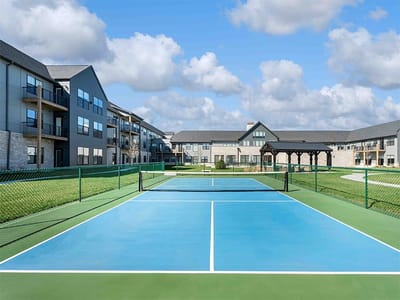 Outdoor tennis courts at a senior living facility
