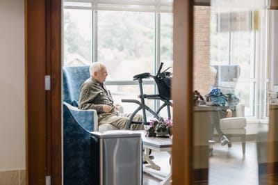 Two residents engaged in conversation in a common area