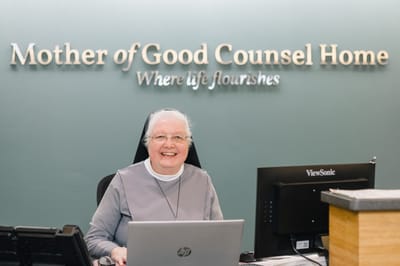 Staff member at the reception desk in the facility