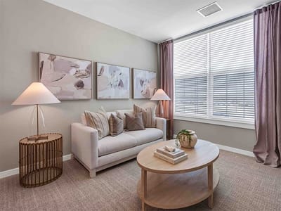 Bright interior of a common area with couch and artwork