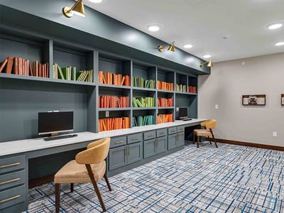 Interior common area with a computer station and bookshelves