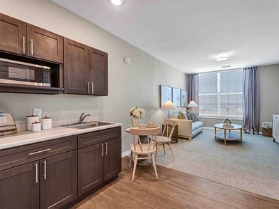 Cozy resident room with kitchenette and seating area