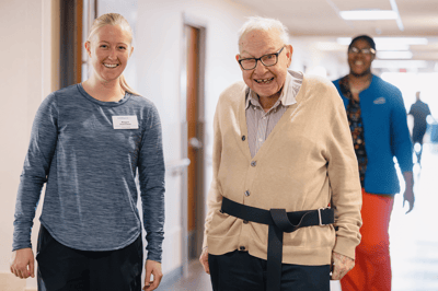 Staff and resident interacting in a corridor