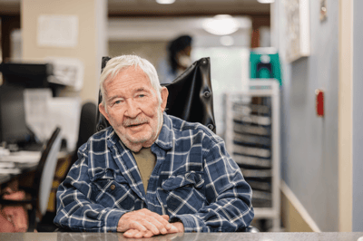 An older man sitting in a common area